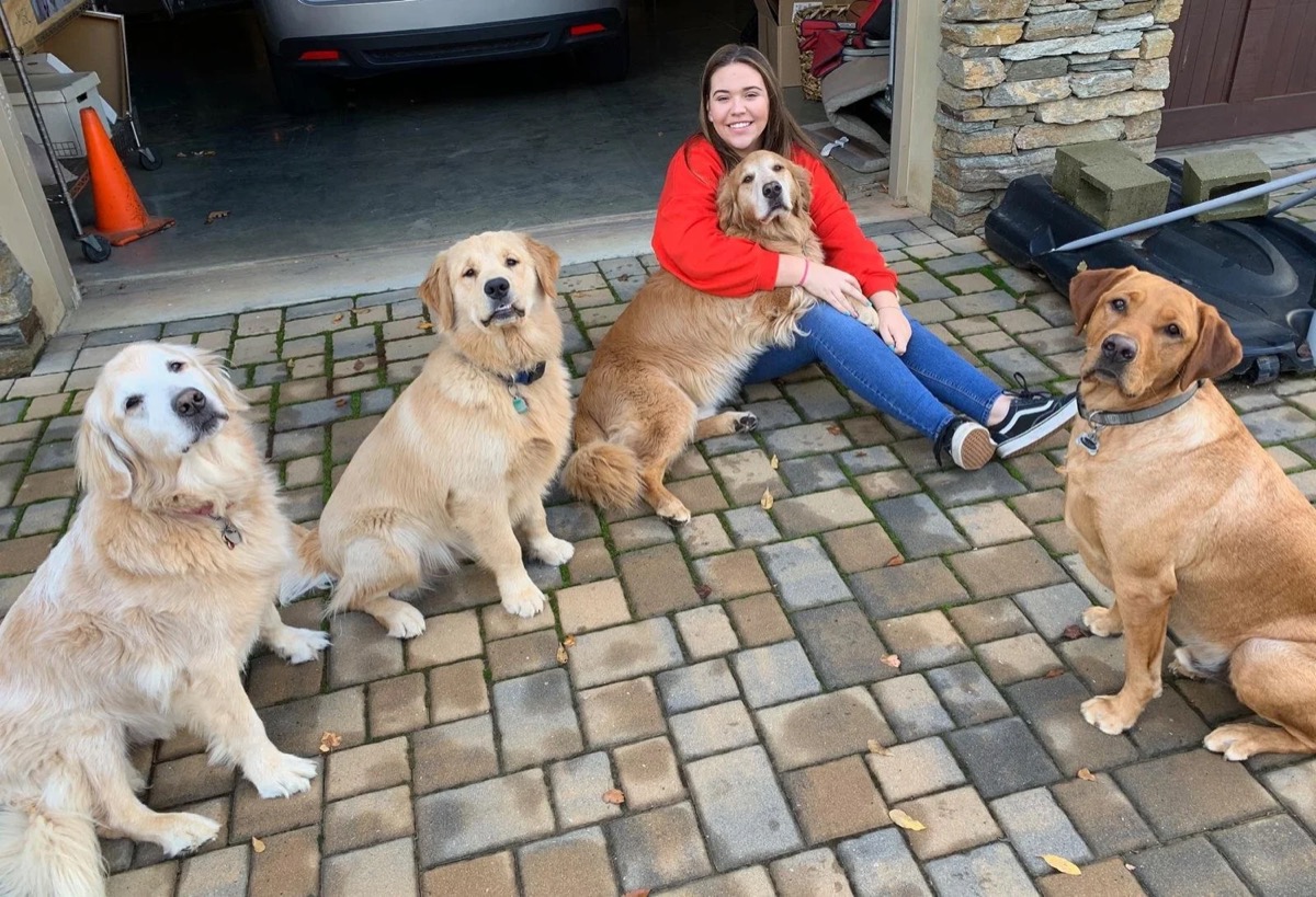 Olivia with dogs she cares for