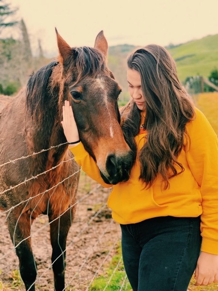 Olivia caring for a horse